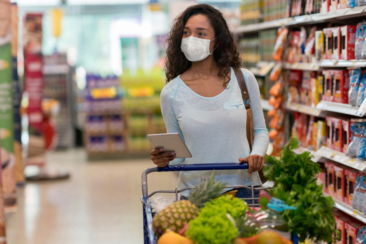 woman in mask shopping for groceries
