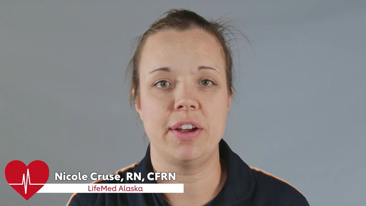 Nicole Cruse, RN, CFRN, LifeMed Alaska in uniform on a grey background
