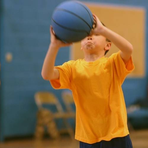 A boy shooting a basket