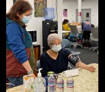 A person learning how to measure their blood pressure