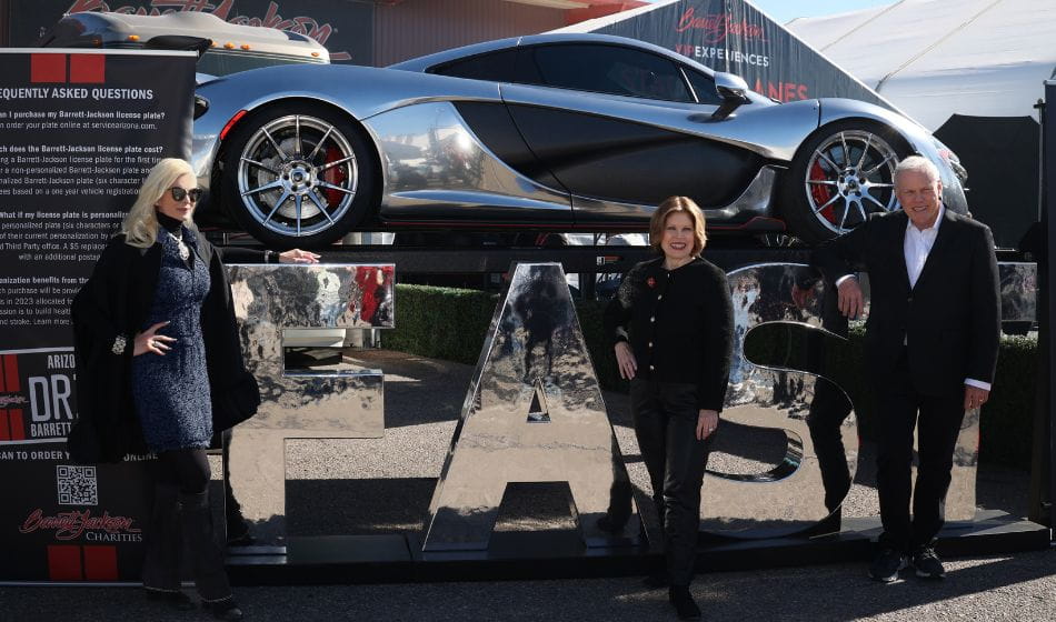Carolyn Jackson with Nancy Brown and Craig Jackson in front of metallic FAST letters and silver car