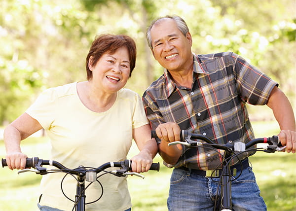 Smiling couple on bikes