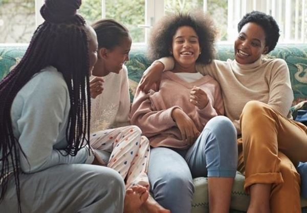 four women sitting on couch