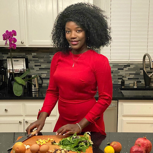 Woman in her kitchen, chopping healthy fruits and vegetables