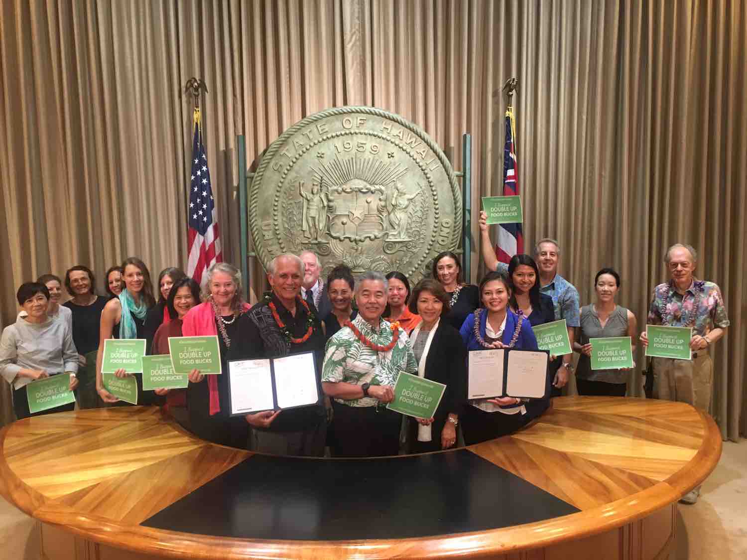 group stands with Governor Ige after he signed into law act 153