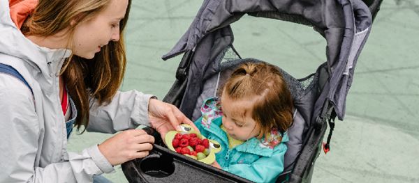 Eat Smart woman feeding baby fruit woman feeding baby fruit