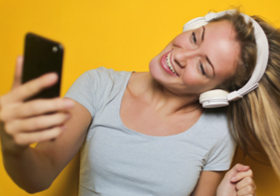 Girl taking a selfie with headphones on
