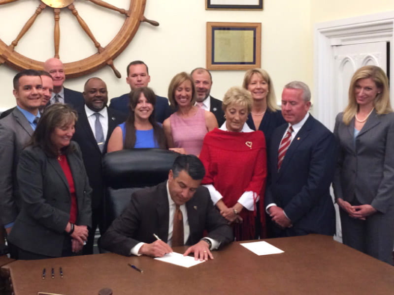 Representatives from the American Heart Association's You're the Cure grassroots network join Nevada state legislators and then-Gov. Brian Sandoval on May 15, 2017, in Carson City as he signs Assembly Bill 85 into law. The law, which took effect that July, requires all Nevada students to receive CPR training as part of their health education before graduating from high school. (American Heart Association)