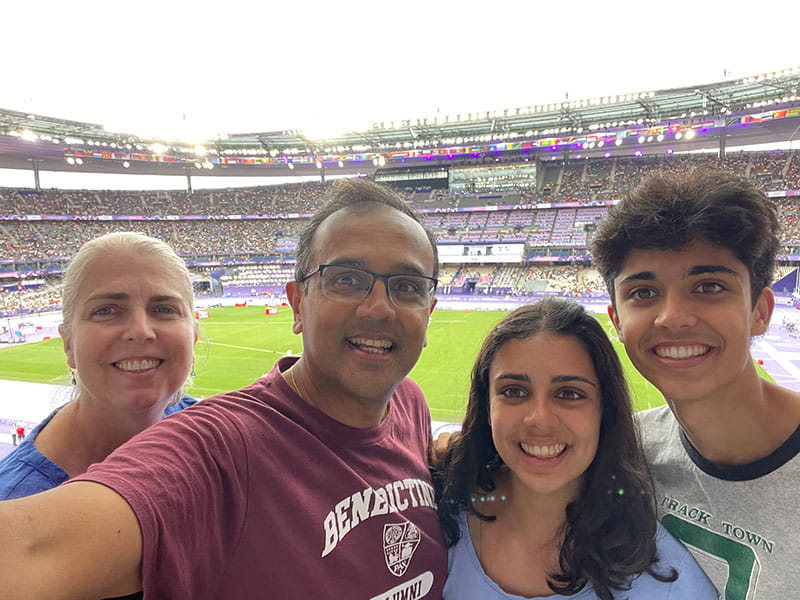 Dr. Manesh Patel with his wife, Dr. Sallie Patel, and their children, Maya and Sanju, take a selfie at the 2024 Summer Olympics in Paris