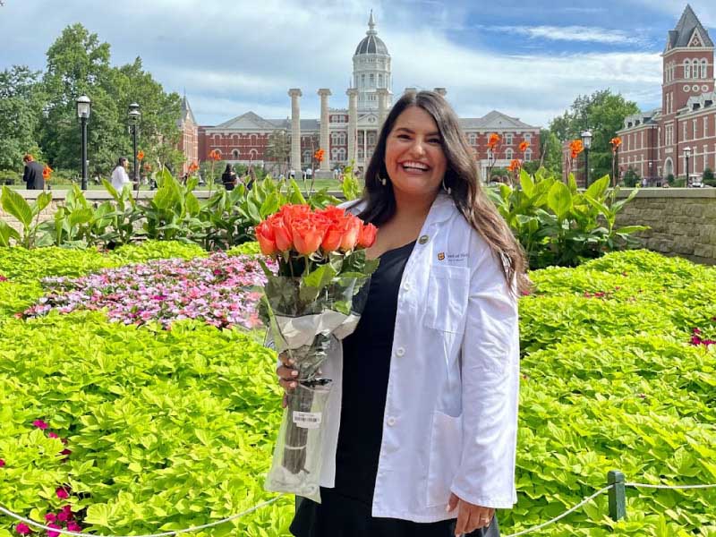 Paola Rivera, who grew up dreaming of becoming a doctor but switched majors after she began to lose her confidence, celebrates her entry into medical school at the University of Missouri School of Medicine's White Coat Ceremony in 2022. (Photo courtesy of Gustavo Rivera)