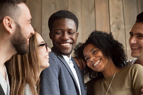 Diverse group of friends smiling at each other