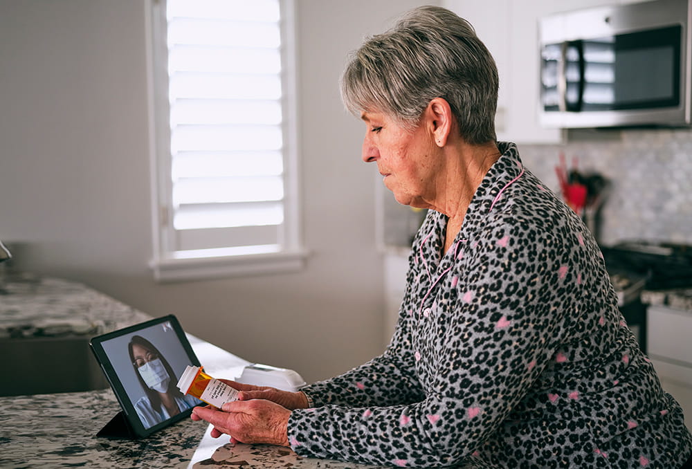 senior woman discussing prescription with telemedicine doctor