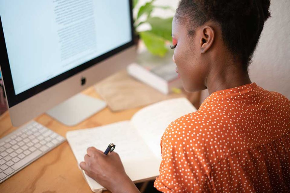 woman writing in her notebook