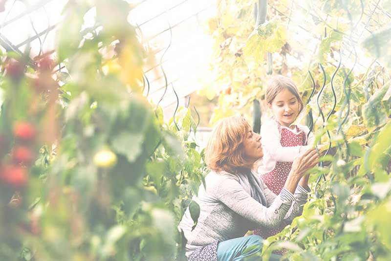 senior woman gardening with child