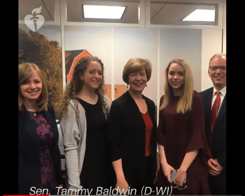You're the Cure advocates take a photo with Senator Tammy Baldwin