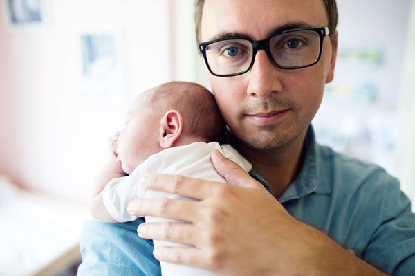 Close up of young father holding child