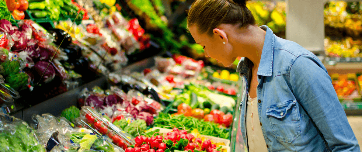 woman buying vegetables at grocery store
