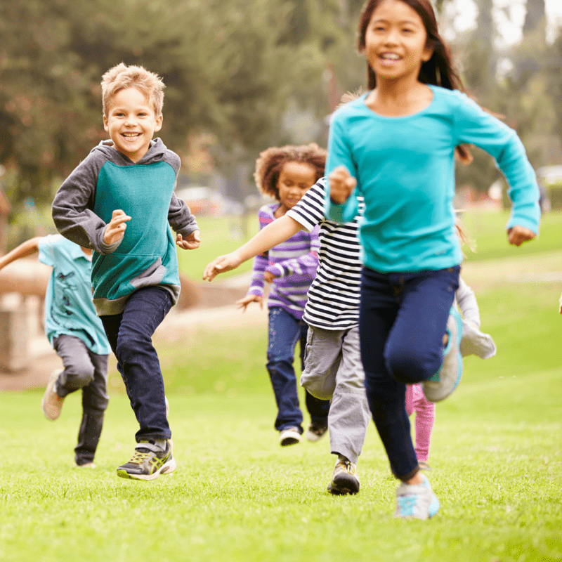 Kids running through a field