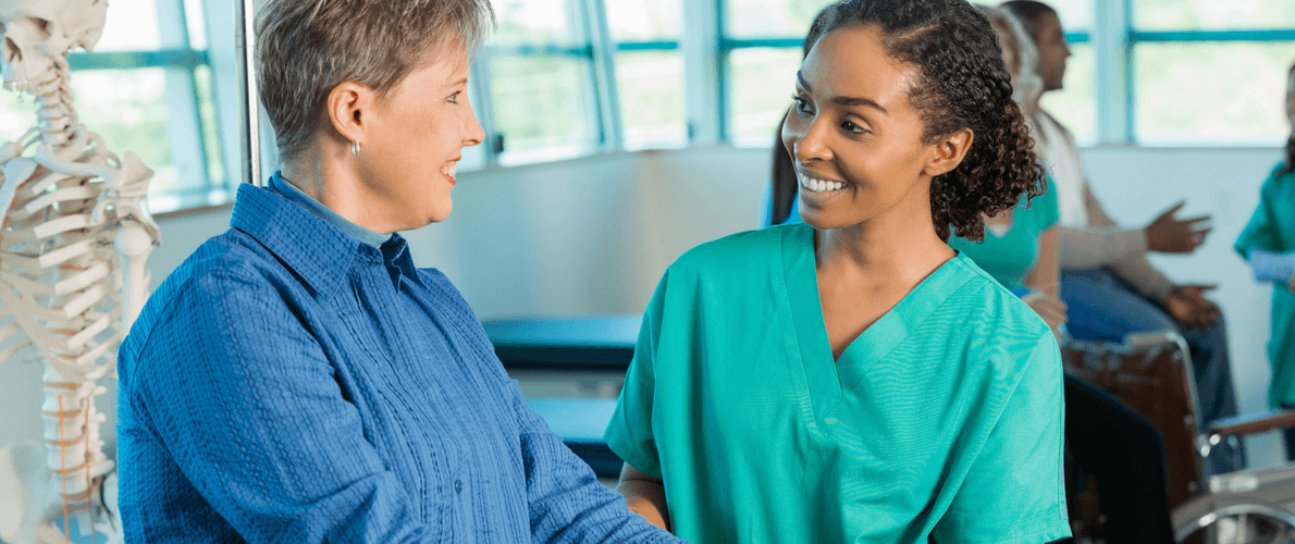 Woman patient meets with young woman nurse