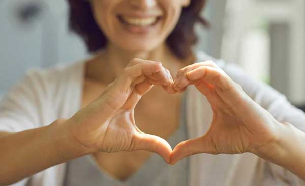 woman making heart with hands