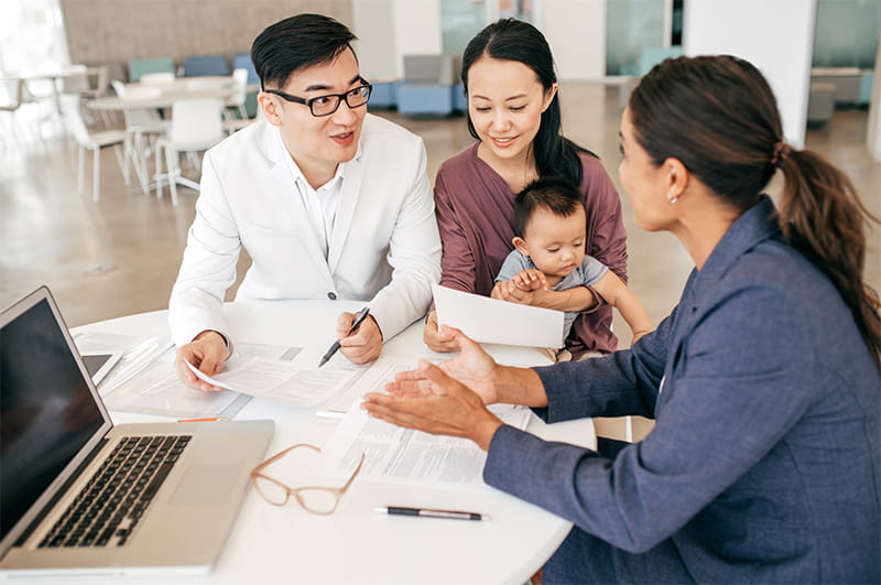 Young family meeting with an advisor at a table in a business setting