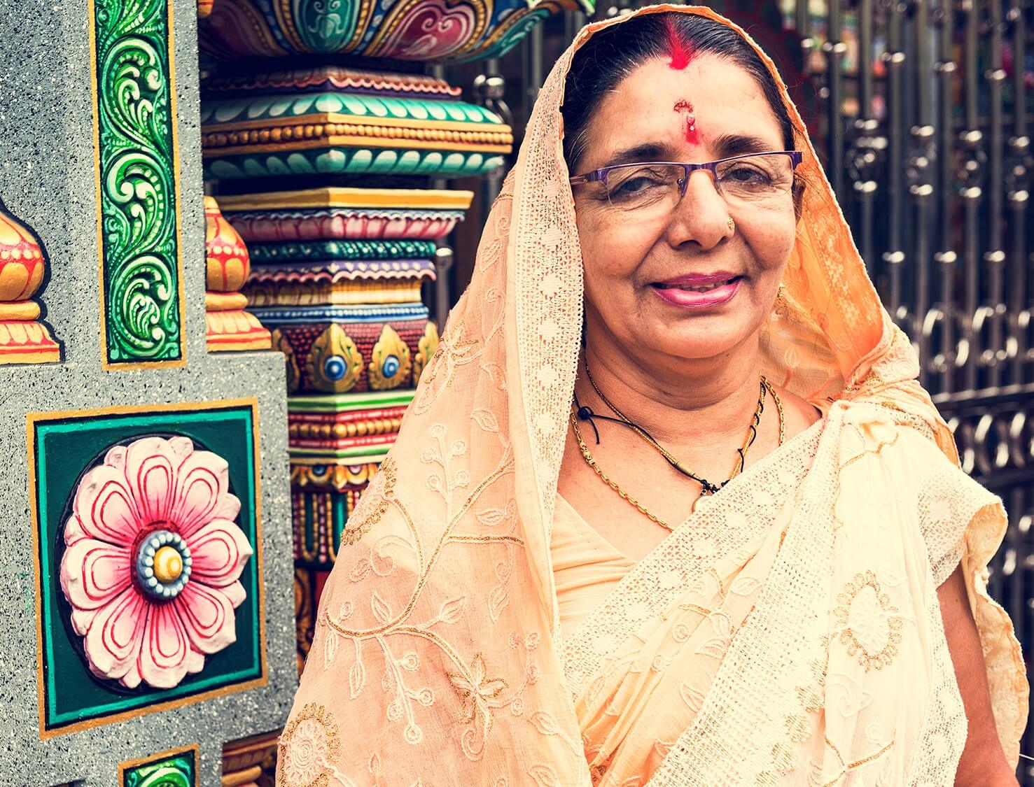 Indian woman in front of temple