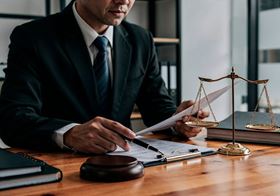 advisor wearing a suit sitting at a desk and examining documents