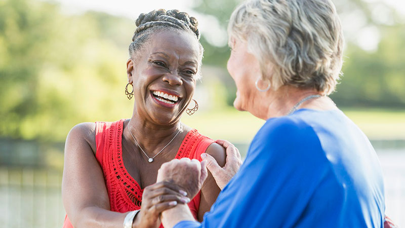 happy multi ethnic woman holding hands