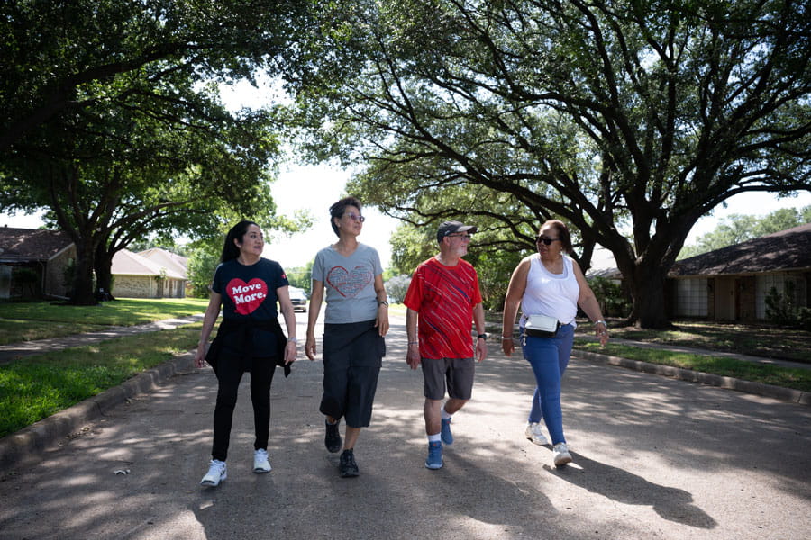 Group of friends walking together in a neighborhood