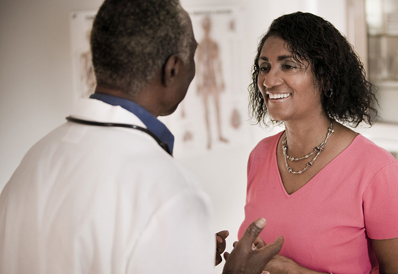 Woman talking to doctor