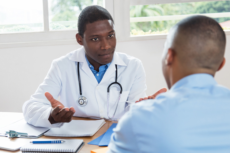 Doctor talking to patient at desk