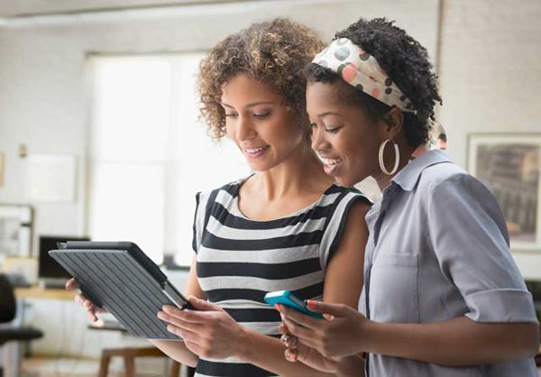 Two women on their mobile devices