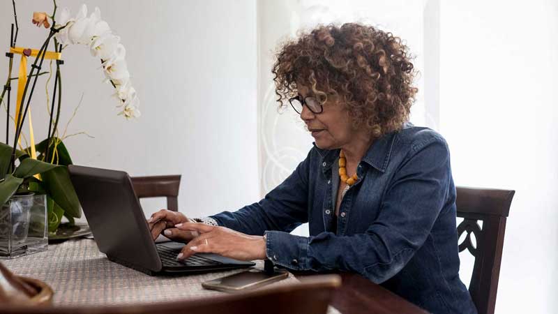 woman researching on her laptop