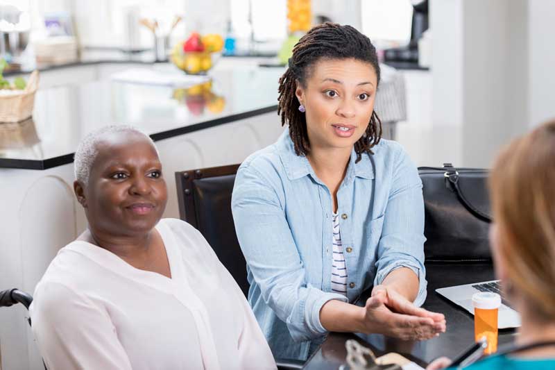 mother and daughter talking to doctor