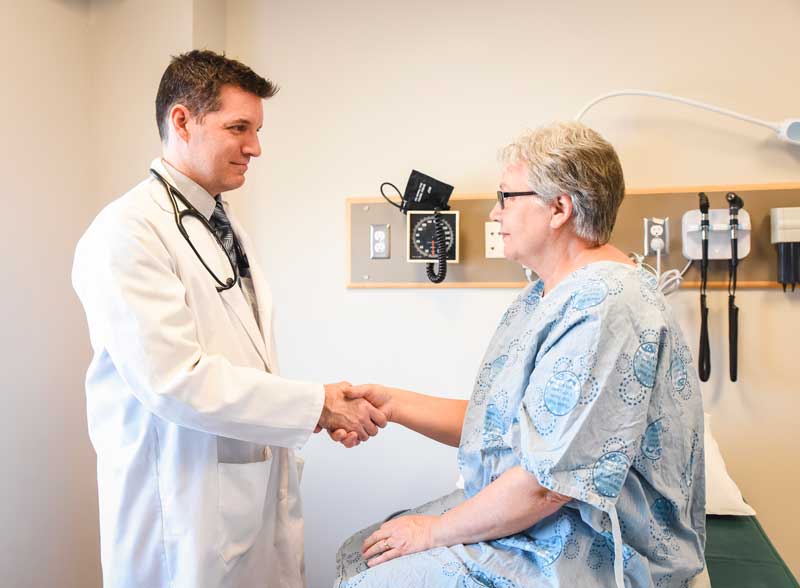 Female patient shaking doctor's hand