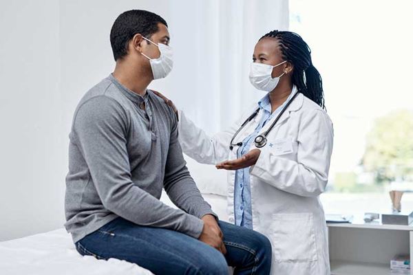 Male patient talking to doctor