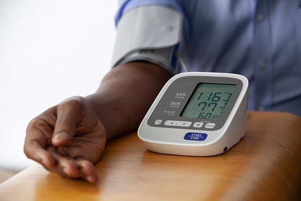 man checking blood pressure