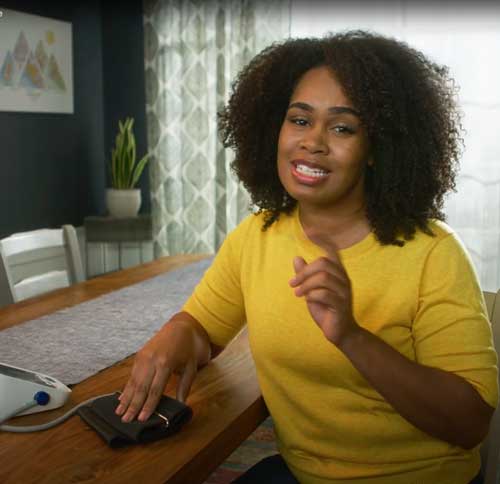 woman checking her blood pressure at home