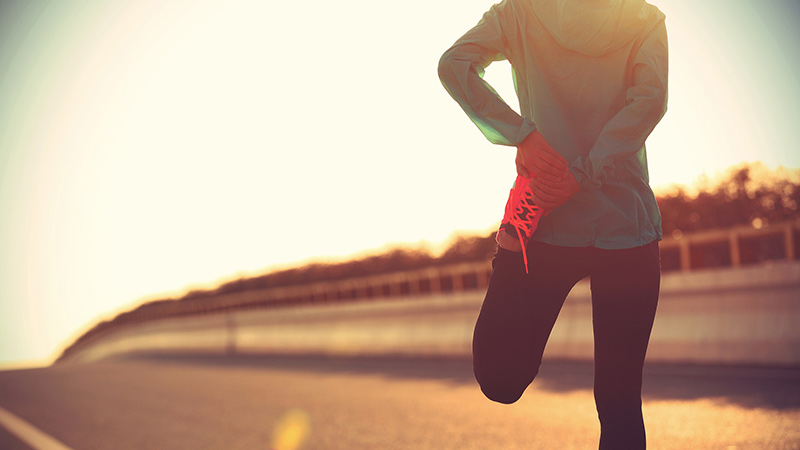 Woman stretching outdoors during workout