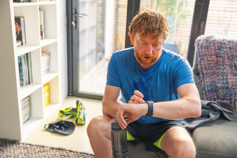 Man checking his smartwatch after a run
