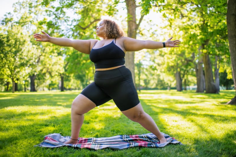 woman practicing yoga outdoors