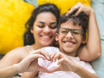 mom and son making heart shape with hands - Pollyana Ventura/E+, Getty Images