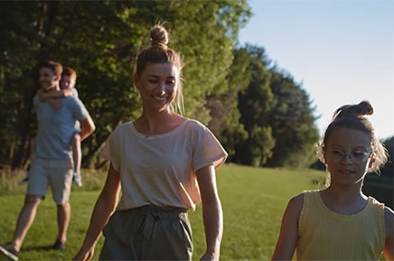 family of four walking outside