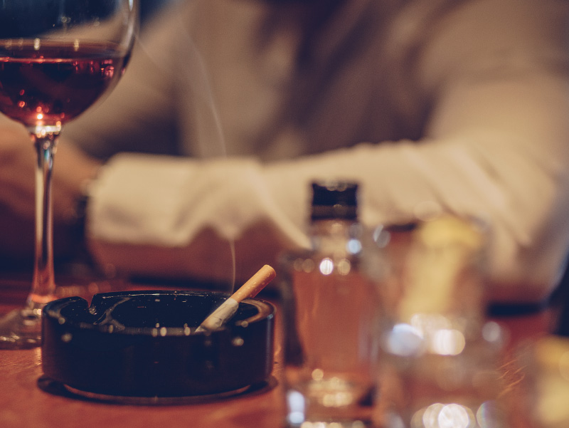 Photo of cigarette and wine glass. (South_agency / Envato Elements)