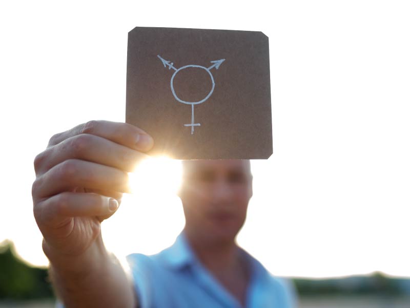 Person holding transgender symbol. (ljubaphoto, Getty Images)