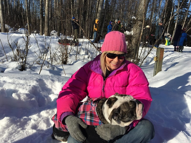 Sue Gaston holds a friendly pup she met while watching the 2017 Iditarod race through her neighborhood in Anchorage, Alaska, after she had a heart attack. (Photo courtesy of Sue Gaston)