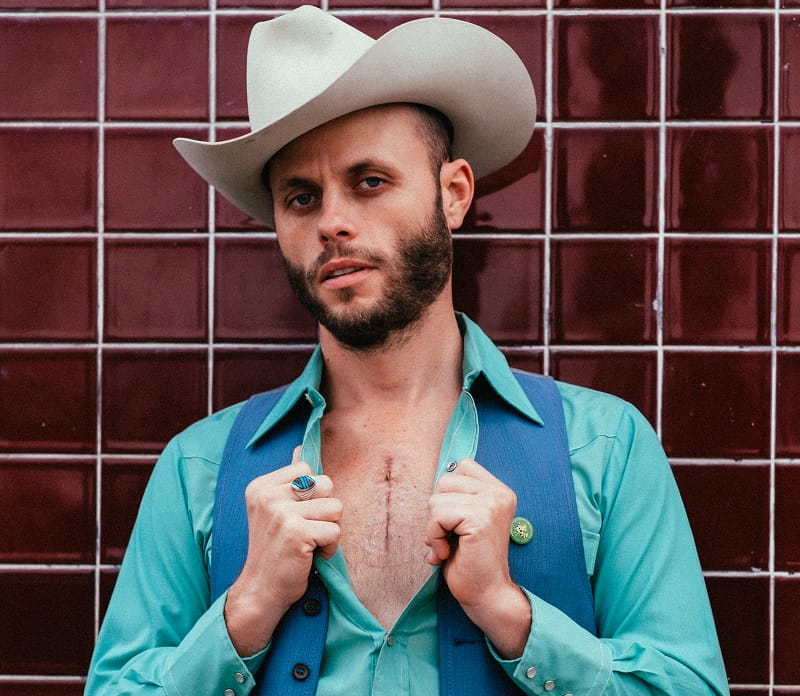 Charley Crockett shows his scar from heart valve replacement surgery in 2018. (Photo courtesy of Lyza Renee)