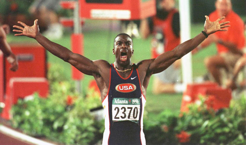 Michael Johnson celebrates after setting a new world record in the men’s 200 meters at the 1996 Olympics. (Photo by Simon Bruty/Staff, Getty Images)