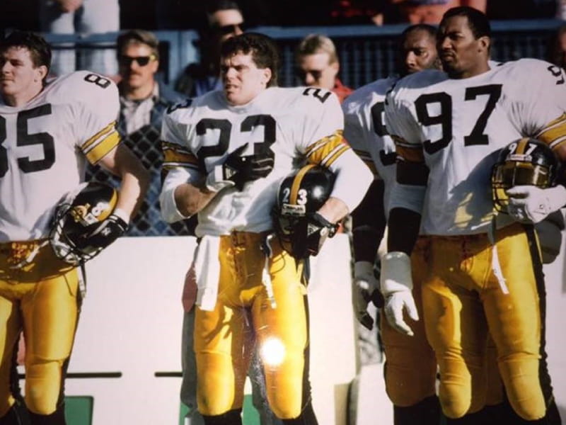 Tim Tyrrell (No. 23) stands between fellow Pittsburgh Steelers Terry O'Shea and Aaron Jones before a game. Tyrrell played for the Steelers in 1989, capping a six-year NFL run that included time with the Atlanta Falcons and Los Angeles Rams. Photo courtesy of Tim Tyrrell