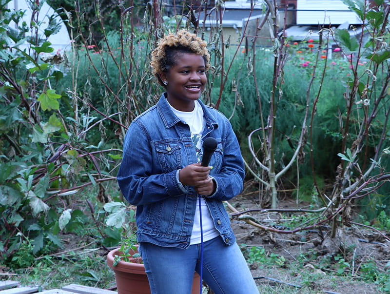 Karyn Hopkins speaking at the farm's 10 year anniversary event in 2019. (Photo courtesy of Urban Tree Connection)